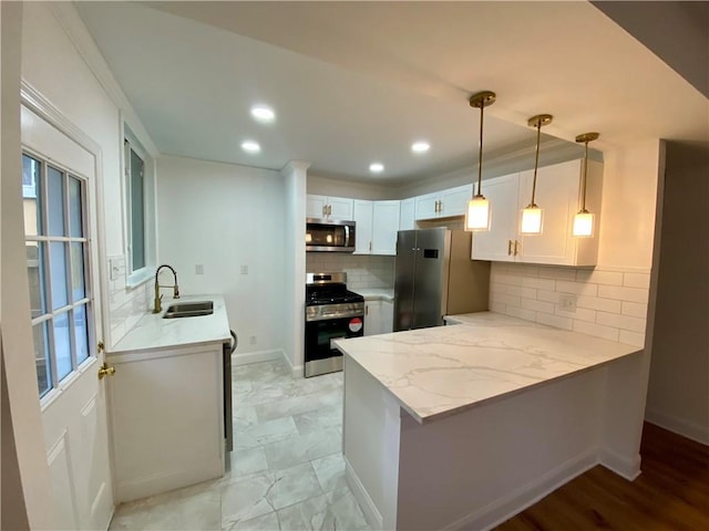 kitchen featuring kitchen peninsula, white cabinetry, sink, and stainless steel appliances