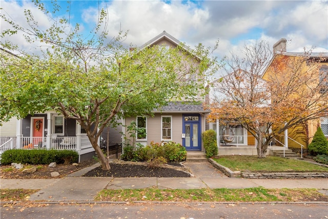 view of property hidden behind natural elements with french doors