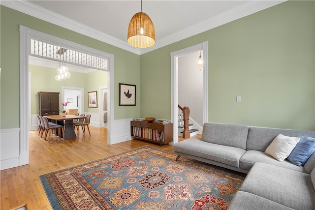 living room with wood-type flooring and ornamental molding