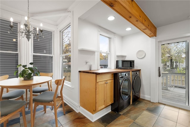 kitchen with beam ceiling, an inviting chandelier, hanging light fixtures, and a healthy amount of sunlight