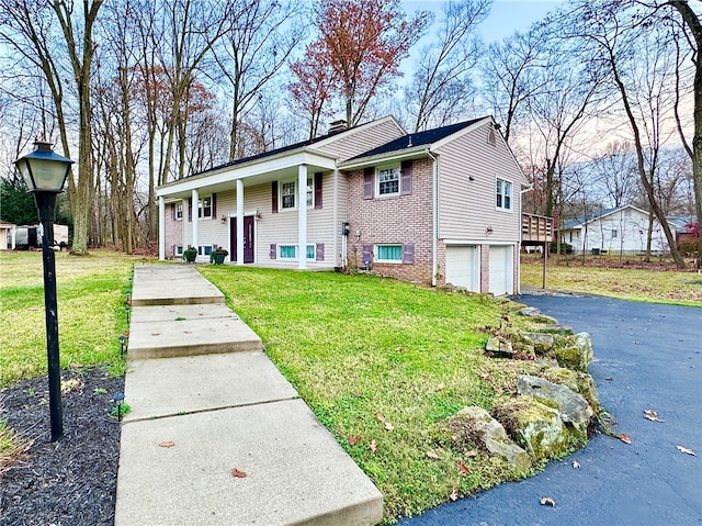 view of home's exterior featuring a lawn and a garage