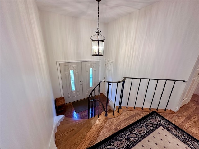 foyer entrance featuring a chandelier and wood-type flooring