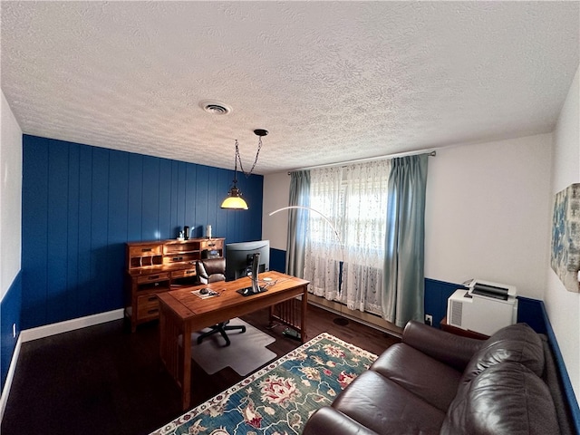 office area with a textured ceiling and dark wood-type flooring