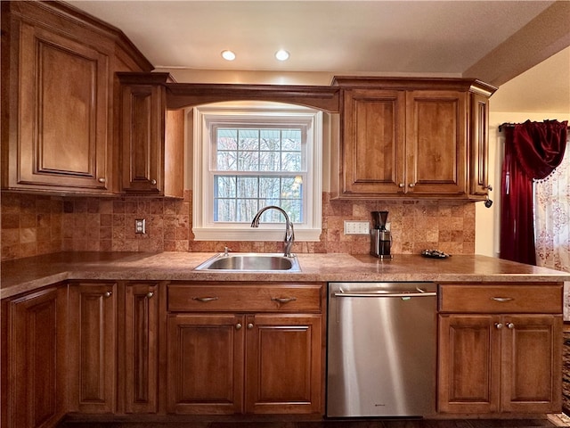 kitchen featuring dishwasher, decorative backsplash, and sink