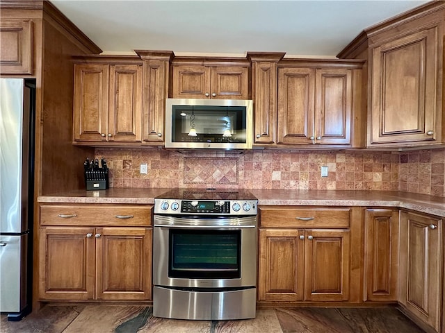 kitchen with appliances with stainless steel finishes and tasteful backsplash