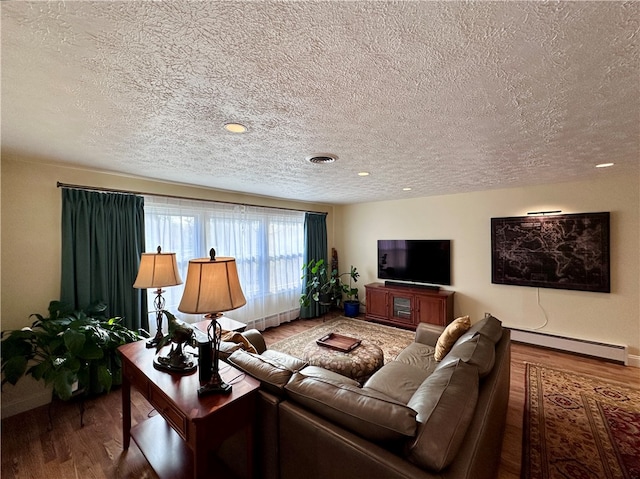 living room featuring hardwood / wood-style floors, a textured ceiling, and a baseboard radiator