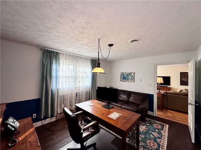 office with hardwood / wood-style flooring and a textured ceiling