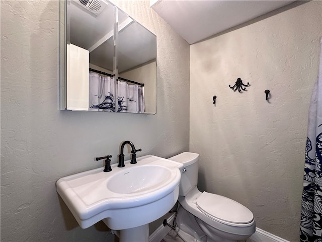 bathroom featuring sink and toilet