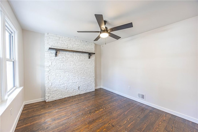 empty room with ceiling fan and dark wood-type flooring