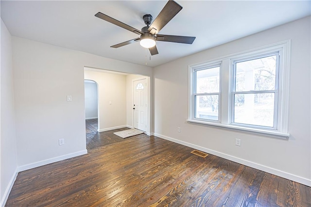 spare room featuring dark hardwood / wood-style flooring and ceiling fan