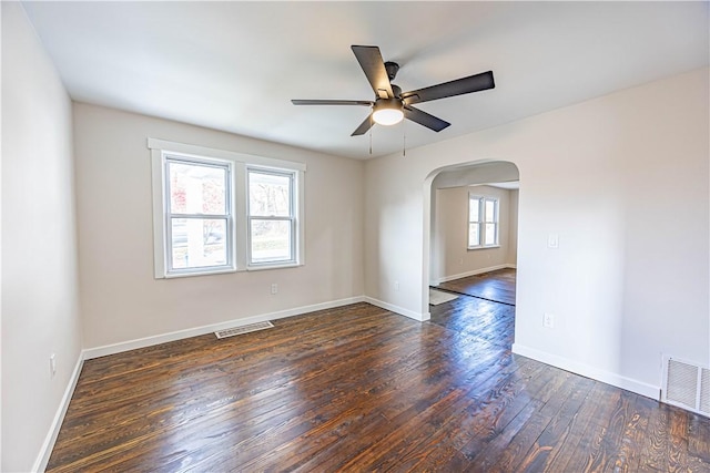 unfurnished room featuring ceiling fan and dark wood-type flooring