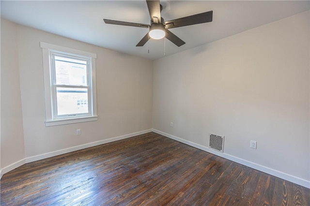 spare room featuring dark hardwood / wood-style floors and ceiling fan