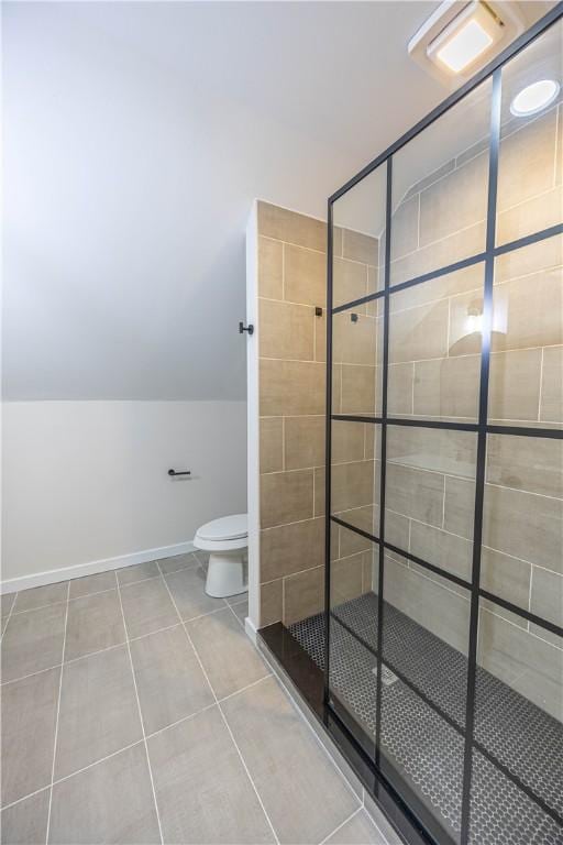 bathroom with tile patterned flooring, toilet, and an enclosed shower