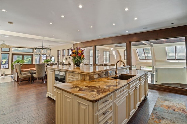 514 Justabout Rd, Peters Twp, PA 15367 - kitchen featuring cream cabinetry, a sink, a large island, dark wood-style floors, and light stone counters