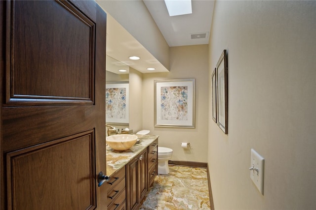 514 Justabout Rd, Peters Twp, PA 15367 - bathroom featuring baseboards, toilet, vanity, and a skylight