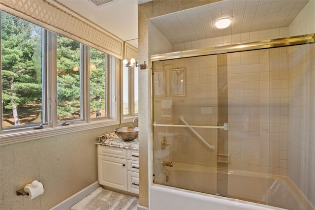 bathroom with vanity and enclosed tub / shower combo