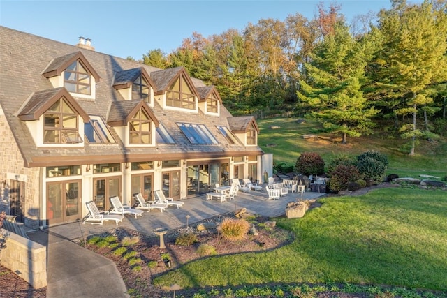 back of property featuring a yard and a patio