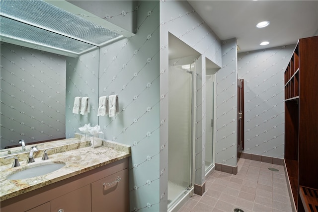 bathroom with vanity and a shower with shower door