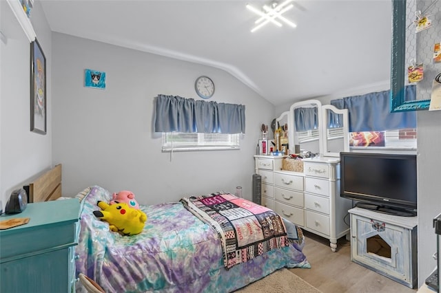 bedroom with light wood-type flooring and lofted ceiling