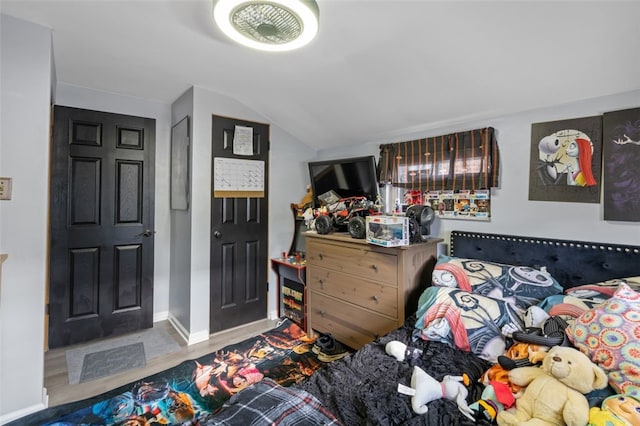 bedroom featuring hardwood / wood-style flooring and lofted ceiling