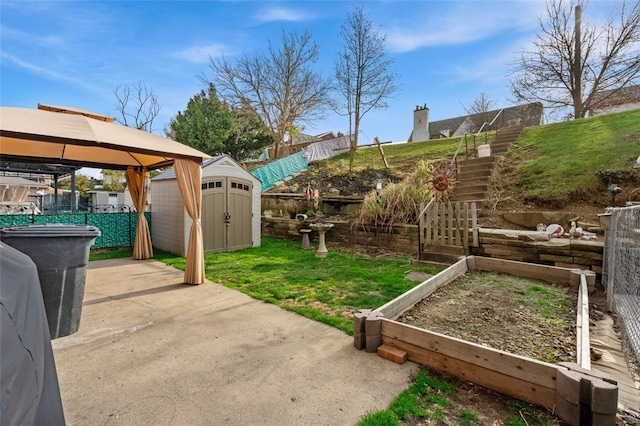 view of yard with a gazebo, a storage unit, and a patio area