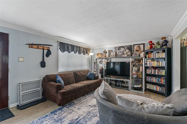 living room featuring hardwood / wood-style floors and crown molding