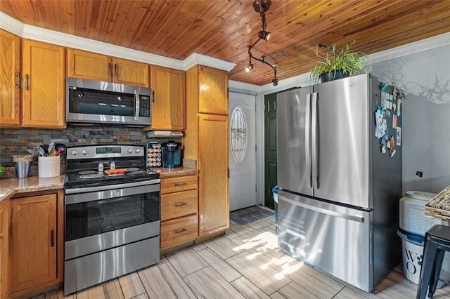 kitchen with decorative backsplash, appliances with stainless steel finishes, track lighting, light stone counters, and wood ceiling