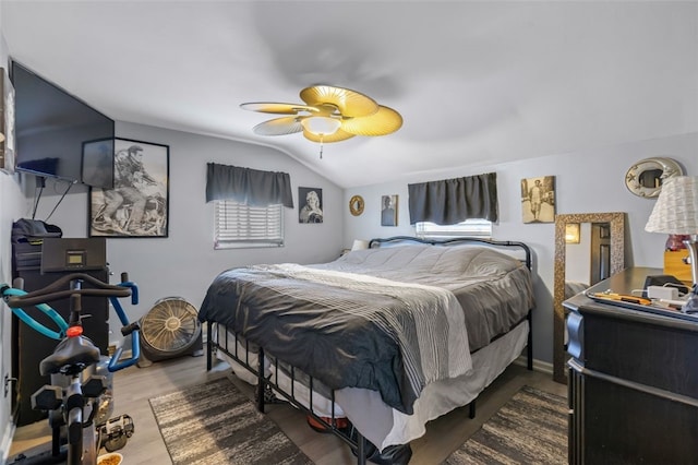 bedroom featuring hardwood / wood-style flooring, ceiling fan, and lofted ceiling