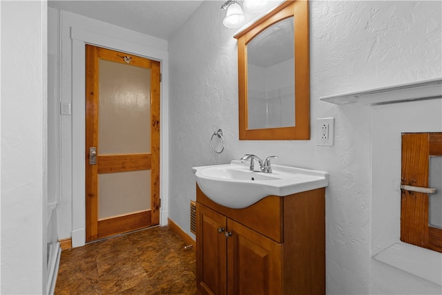 bathroom with vanity and a textured ceiling