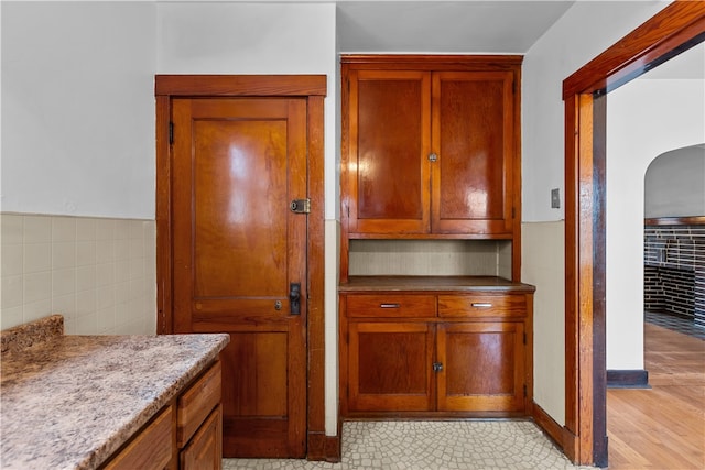 kitchen featuring light hardwood / wood-style floors and light stone counters