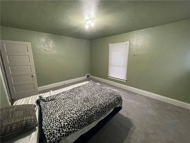 bedroom with carpet and a textured ceiling