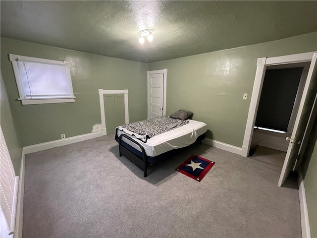 bedroom featuring light carpet and a textured ceiling