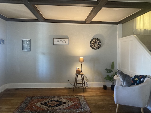 living area featuring beamed ceiling, dark hardwood / wood-style flooring, and coffered ceiling