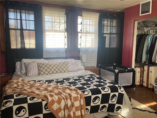 bedroom featuring wood-type flooring and a closet