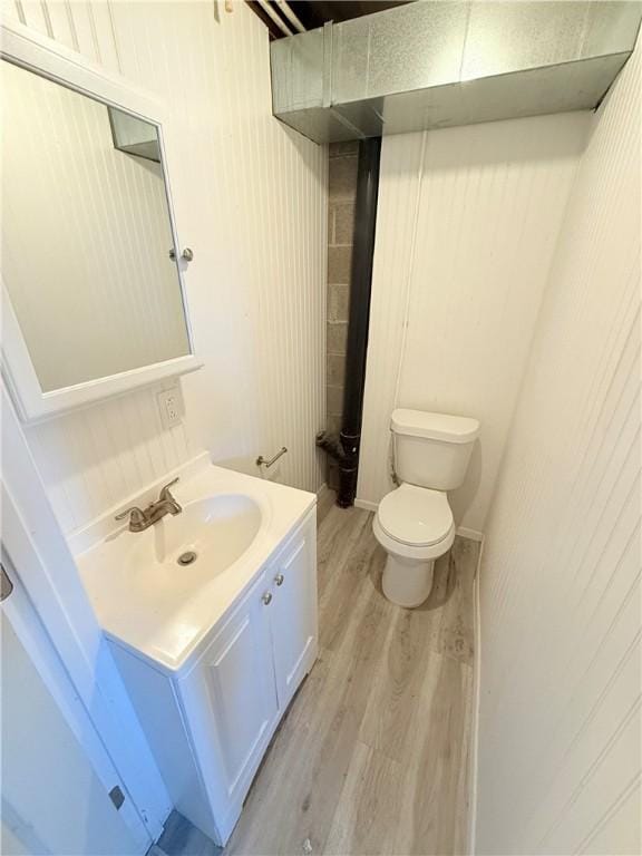 bathroom featuring vanity, toilet, and wood finished floors