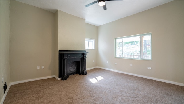 unfurnished living room featuring light carpet and ceiling fan