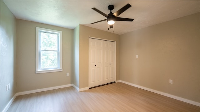 unfurnished bedroom with a closet, ceiling fan, and light hardwood / wood-style floors