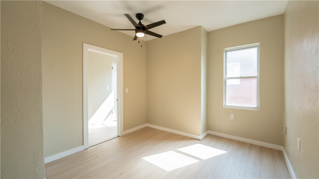 spare room with light hardwood / wood-style floors and ceiling fan