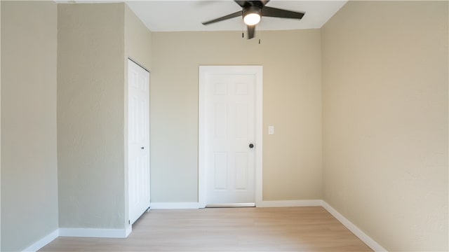 empty room with ceiling fan and light hardwood / wood-style floors