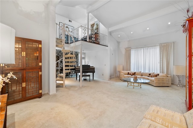 carpeted living room featuring beam ceiling and high vaulted ceiling