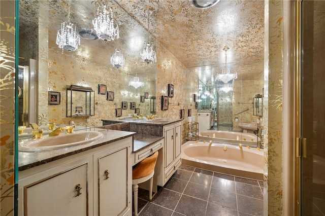 bathroom with tile patterned floors, a tub to relax in, and vanity