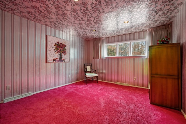 unfurnished room featuring carpet flooring and baseboard heating