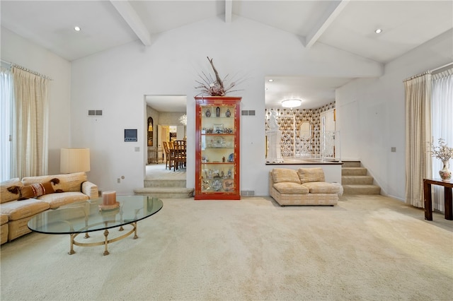 carpeted living room featuring lofted ceiling with beams