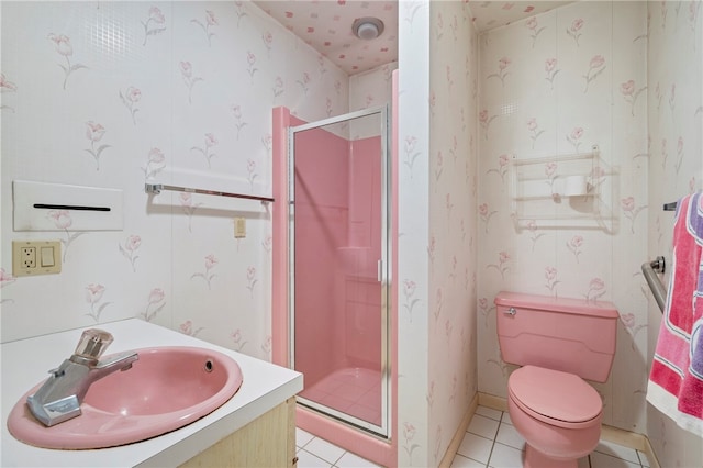 bathroom featuring tile patterned floors, vanity, toilet, and walk in shower