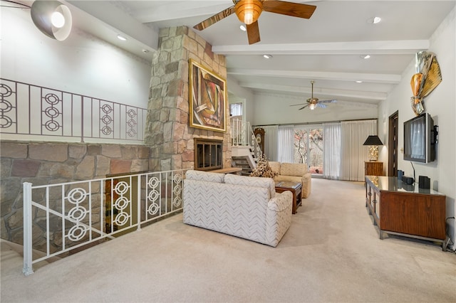 living room featuring carpet flooring, lofted ceiling with beams, ceiling fan, and a stone fireplace