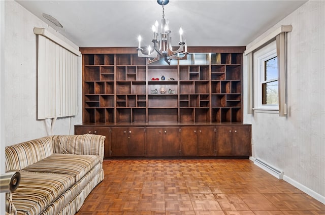 living room featuring a notable chandelier, parquet floors, and baseboard heating