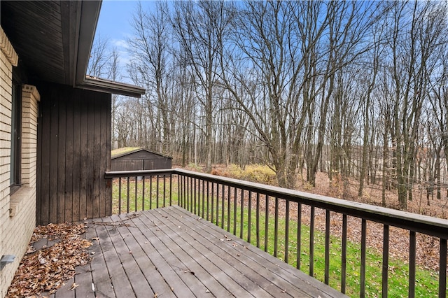 wooden terrace with a storage shed