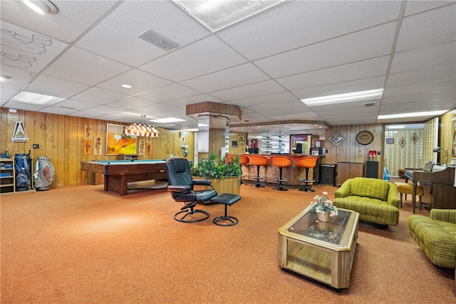 recreation room featuring indoor bar, a paneled ceiling, wooden walls, carpet, and pool table