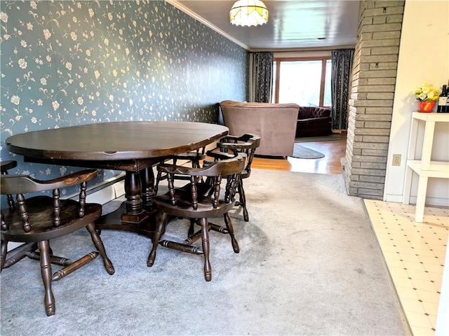 dining space featuring crown molding