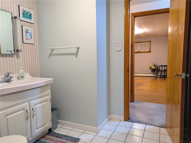 bathroom featuring tile patterned flooring, vanity, and a baseboard heating unit